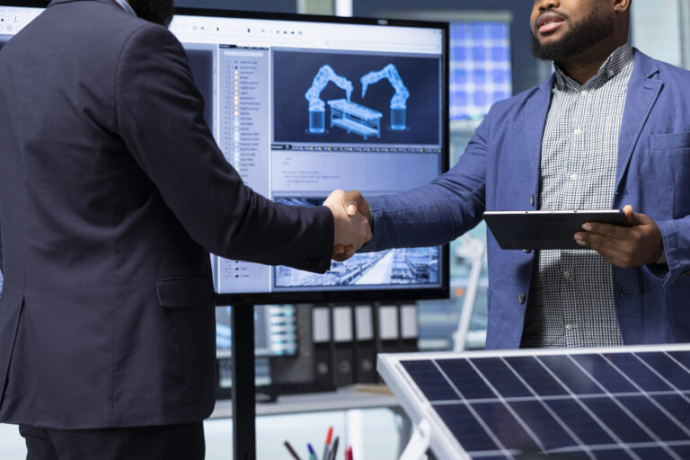 Solar panels plant executive doing handshake with investor, making deal, close up. Photovoltaics factory manager meeting with shareholder to discuss business operations, shaking hands
